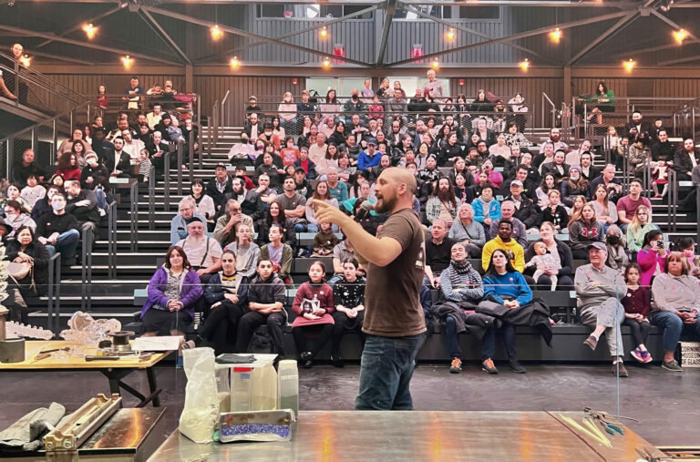 Elliot addressing the crowd at Corning museum of glass